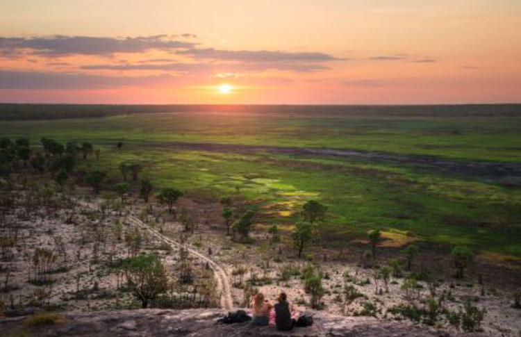 Couple watch sunset in Ubirr