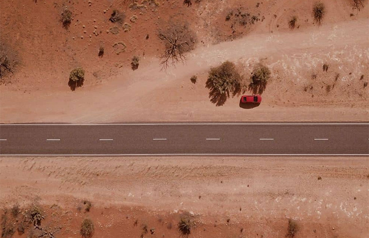 Aerial shot of the red earth around the road in Alice Springs